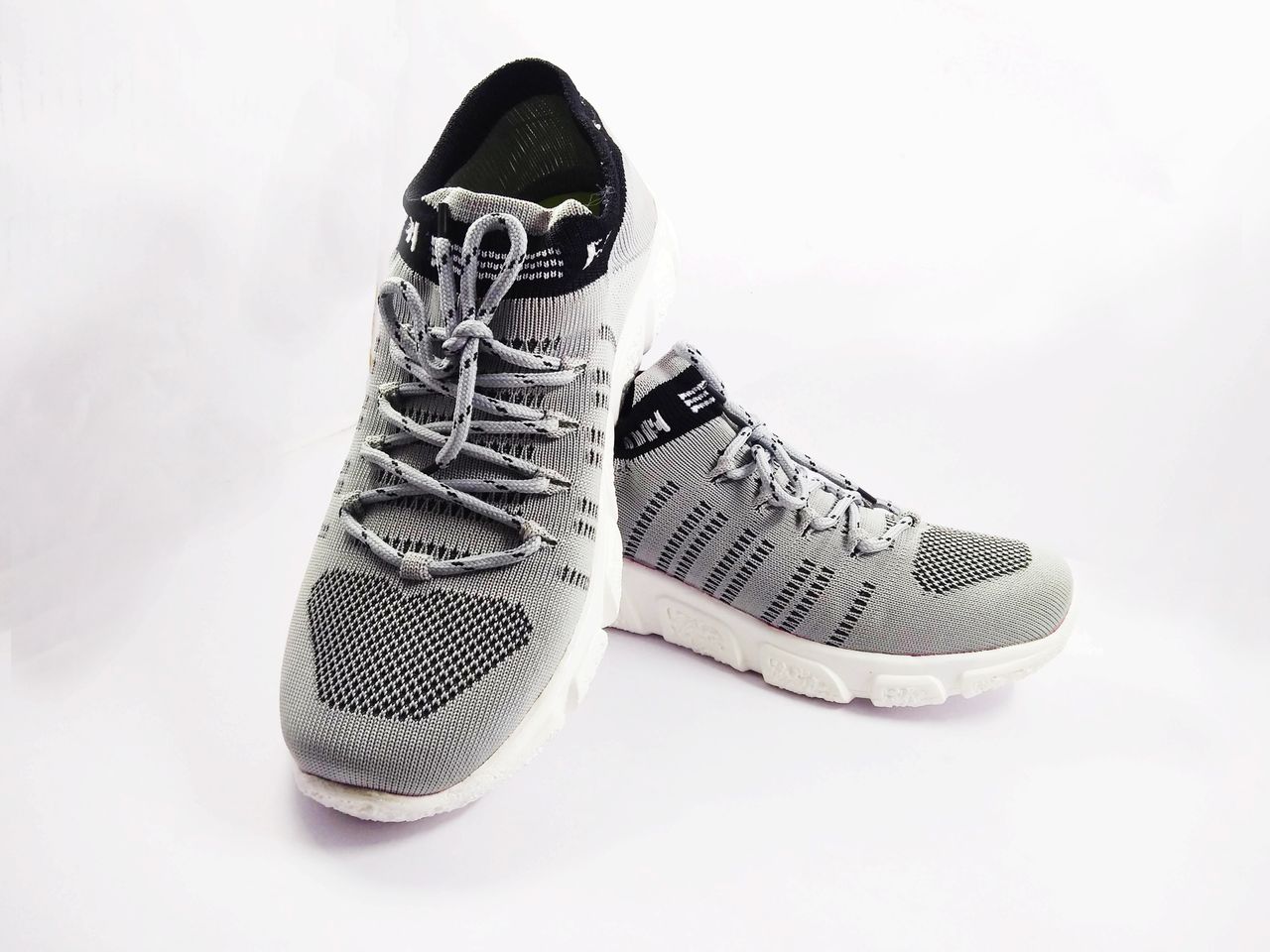 services-01 Detailed close-up of stylish grey sneakers, perfect for sports and casual wear on a white background.